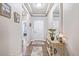 Bright entryway with wood-look floors, decorative rug and table; neutral walls at 11884 Barrentine Loop, Parker, CO 80138