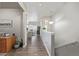 Bright hallway leading to living spaces with wood-look floors and neutral paint at 11884 Barrentine Loop, Parker, CO 80138