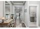 Inviting hallway featuring wood floors, stylish console table, and neutral paint at 11884 Barrentine Loop, Parker, CO 80138