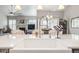 Kitchen island with white countertops, farmhouse sink and views to the living room and dining room areas at 11884 Barrentine Loop, Parker, CO 80138