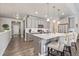 Bright kitchen with gray cabinets, quartz countertops, an island with seating, and stainless steel appliances at 11884 Barrentine Loop, Parker, CO 80138