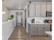 Hallway view of gray kitchen cabinets with white countertops, a subway tile backsplash, and stainless steel appliances at 11884 Barrentine Loop, Parker, CO 80138