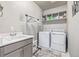 This spacious laundry room includes a sink, washer, dryer, and hanging rack at 11884 Barrentine Loop, Parker, CO 80138