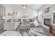 Cozy living room with plush gray seating, fireplace, and vaulted ceiling at 11884 Barrentine Loop, Parker, CO 80138