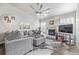 Bright living room with plush seating, fireplace, ceiling fan, and neutral decor at 11884 Barrentine Loop, Parker, CO 80138