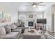 Spacious living room with a cozy fireplace, vaulted ceiling, and a plush sofa at 11884 Barrentine Loop, Parker, CO 80138