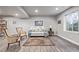 Basement living area with a comfortable sofa, two patterned chairs, and an area rug at 11884 Barrentine Loop, Parker, CO 80138