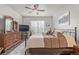 Spacious main bedroom features a ceiling fan, shuttered windows, neutral decor and a wooden dresser set at 11884 Barrentine Loop, Parker, CO 80138