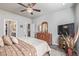 Comfortable main bedroom with a ceiling fan and decor that includes a rustic dresser and large television at 11884 Barrentine Loop, Parker, CO 80138