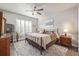 Relaxing main bedroom featuring a ceiling fan, shuttered windows, neutral decor, and ample natural light at 11884 Barrentine Loop, Parker, CO 80138