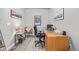 This home office includes neutral colors and a large desk with lots of natural light at 11884 Barrentine Loop, Parker, CO 80138