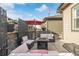 Cozy patio featuring a seating area, a fire pit, stylish decor, and a red umbrella at 11884 Barrentine Loop, Parker, CO 80138