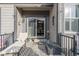 Comfortable porch with lounge chair, bench, and decor, leading to a sliding glass door at 11884 Barrentine Loop, Parker, CO 80138