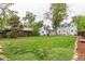 Expansive backyard with lush green grass and mature trees, perfect for outdoor activities and relaxation at 134 S 5Th Ave, Brighton, CO 80601
