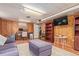 Finished basement featuring wood paneled walls, drop ceilings, and plush seating at 134 S 5Th Ave, Brighton, CO 80601