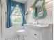 Bathroom featuring a vanity sink with a blue mirror and a window bringing in natural light at 134 S 5Th Ave, Brighton, CO 80601