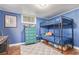 bedroom featuring blue walls, wood floors, and a cozy bunk bed at 134 S 5Th Ave, Brighton, CO 80601