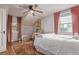 Bedroom with a ceiling fan, two windows, and a dollhouse next to a bookcase at 134 S 5Th Ave, Brighton, CO 80601