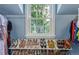 Walk-in closet featuring a large window, shoe racks and ample storage for clothing at 134 S 5Th Ave, Brighton, CO 80601
