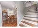 Elegant dining room featuring a vintage display case, wood floors, and a staircase to the upper level at 134 S 5Th Ave, Brighton, CO 80601