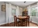 Light-filled dining room features hardwood floors, neutral walls, and a wooden dining set for a cozy atmosphere at 134 S 5Th Ave, Brighton, CO 80601