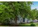 Attractive home showcasing a well-maintained exterior with blue shutters, a cozy porch, and mature trees providing shade at 134 S 5Th Ave, Brighton, CO 80601