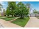 Home featuring a well-manicured front lawn with a stone walkway and driveway leading to a detached garage at 134 S 5Th Ave, Brighton, CO 80601