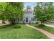 Charming home featuring a lush front yard and a welcoming stone walkway leading to the front door at 134 S 5Th Ave, Brighton, CO 80601