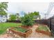 Backyard garden featuring raised beds and mature trees at 134 S 5Th Ave, Brighton, CO 80601