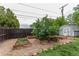 Backyard gardening area with raised garden beds and mature foliage at 134 S 5Th Ave, Brighton, CO 80601