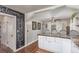 Charming kitchen featuring an eat-in counter with white cabinets, marble countertops, and a chalkboard wall at 134 S 5Th Ave, Brighton, CO 80601