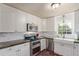 Well-equipped kitchen featuring a farmhouse sink, stainless steel appliances, and ample counter space at 134 S 5Th Ave, Brighton, CO 80601