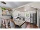 Bright kitchen featuring white cabinetry, stainless steel appliances, and a counter with barstool seating at 134 S 5Th Ave, Brighton, CO 80601