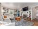 Cozy living room with built-in bookshelves, fireplace, and a comfortable sectional sofa at 134 S 5Th Ave, Brighton, CO 80601