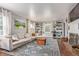 Bright living room with a large sectional sofa, fireplace, and built-in shelving for storage and display at 134 S 5Th Ave, Brighton, CO 80601