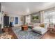 Inviting living room with a large sectional sofa and a stylish area rug over hardwood floors at 134 S 5Th Ave, Brighton, CO 80601