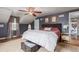 Comfortable main bedroom showcasing a dark accent wall, ceiling fan, and hardwood flooring at 134 S 5Th Ave, Brighton, CO 80601