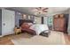 Inviting main bedroom featuring a dark accent wall, ceiling fan, and ample closet space at 134 S 5Th Ave, Brighton, CO 80601