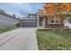 Charming home with a brick facade, attached garage, and a well-maintained lawn at 1064 Lily Ct, Highlands Ranch, CO 80126