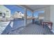 Covered back porch with gray composite decking, red table, and two gray chairs at 1143 Williams Loop, Elizabeth, CO 80107