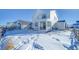 View of home's backyard in winter, snow-covered ground, and wooden fence at 1143 Williams Loop, Elizabeth, CO 80107