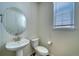 Clean bathroom with pedestal sink and window at 1143 Williams Loop, Elizabeth, CO 80107