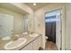 Bathroom with double sinks, a large mirror and a shower/tub combo at 1143 Williams Loop, Elizabeth, CO 80107
