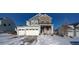 Two-story house with stone and siding, three-car garage, and snowy front yard at 1143 Williams Loop, Elizabeth, CO 80107