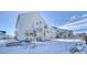 Two-story home's exterior, white siding, and snow-covered front yard at 1143 Williams Loop, Elizabeth, CO 80107