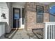Modern front door with stone surround and welcome mat at 1143 Williams Loop, Elizabeth, CO 80107