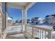 Covered porch overlooking a snowy neighborhood at 1143 Williams Loop, Elizabeth, CO 80107