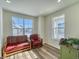 Cozy living room with hardwood floors and large windows at 1143 Williams Loop, Elizabeth, CO 80107