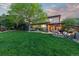 Expansive backyard featuring a well-manicured lawn and multiple outdoor living spaces at 6874 Raspberry Run, Littleton, CO 80125