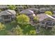 Aerial view of a landscaped backyard featuring a patio dining area and a cozy fire pit with built-in seating at 6874 Raspberry Run, Littleton, CO 80125